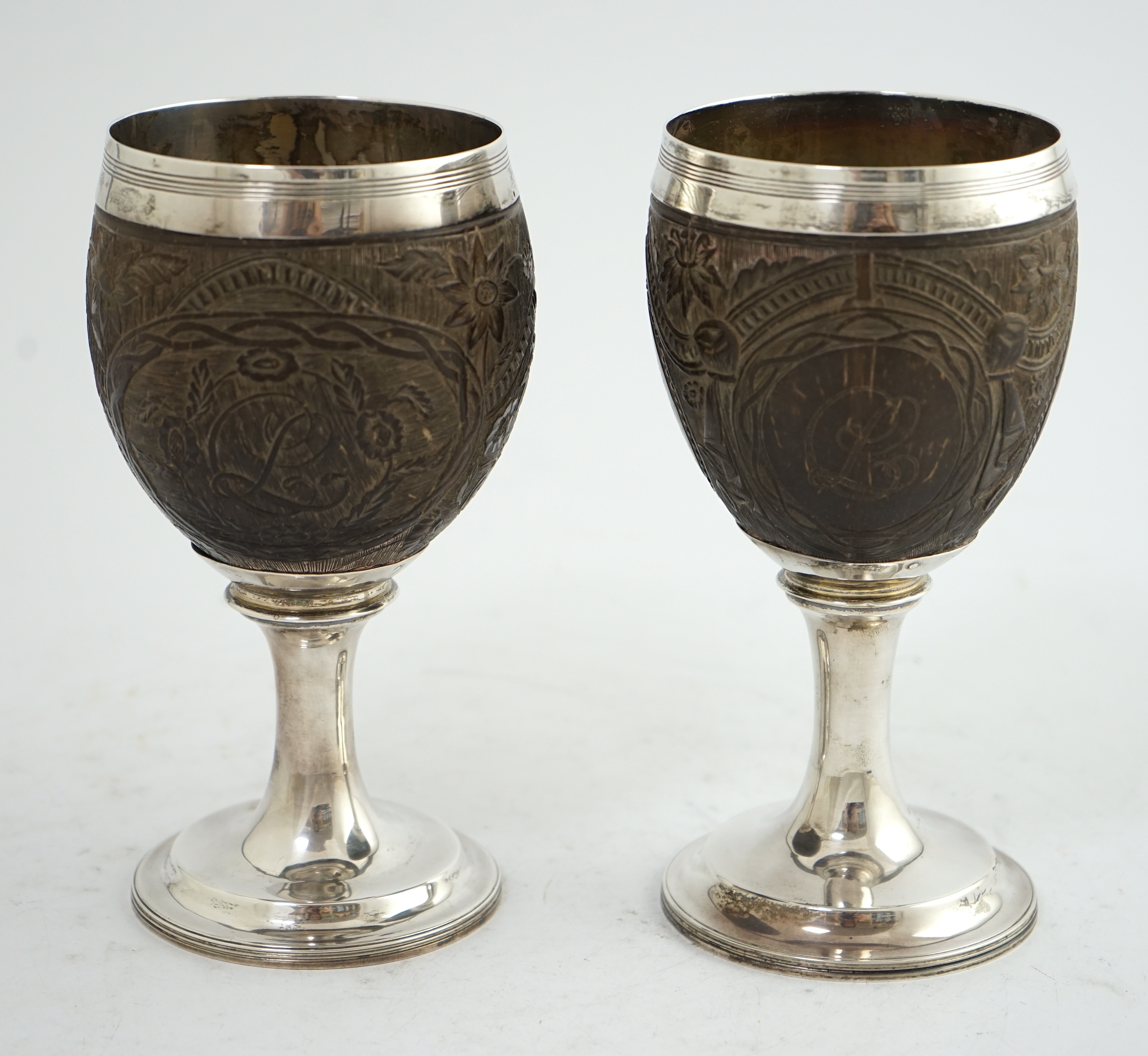 A pair of George III silver mounted coconut cups, maker I.T?